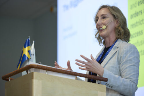 TEG CEO Jennifer Morrell speaking at a podium during a conference in Stockholm, Sweden